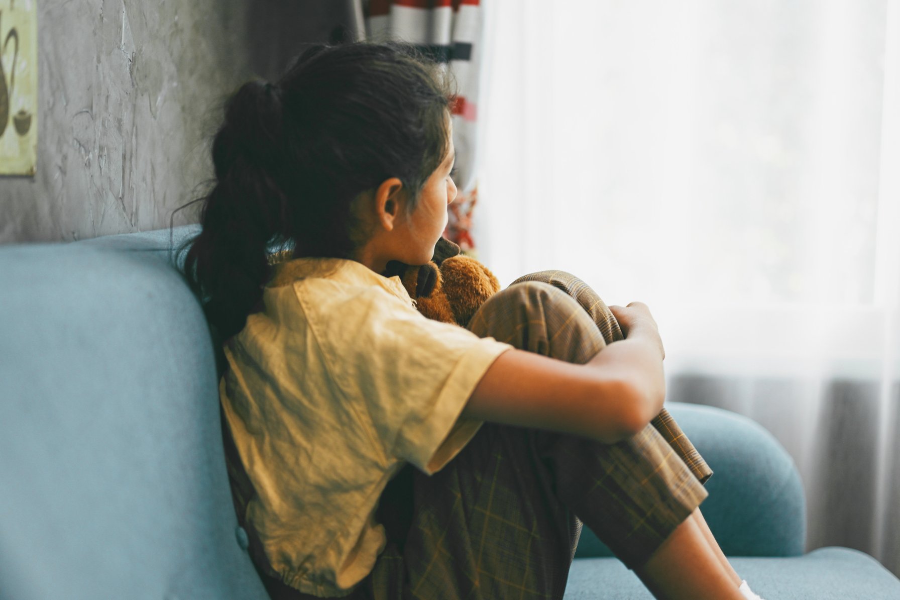 Young girl staring out the window
