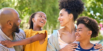 A family laughing together outdoors